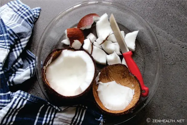 Removing coconut meat with knife